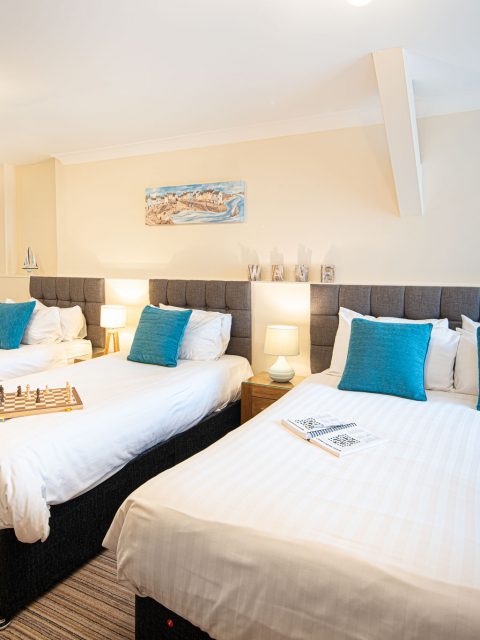 double and twin beds in family room at the gwbert hotel