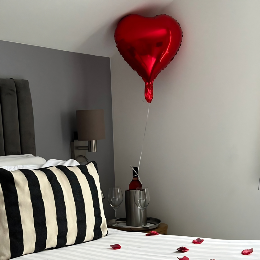 Heloium heart shaped balloon and a bottle of wine
